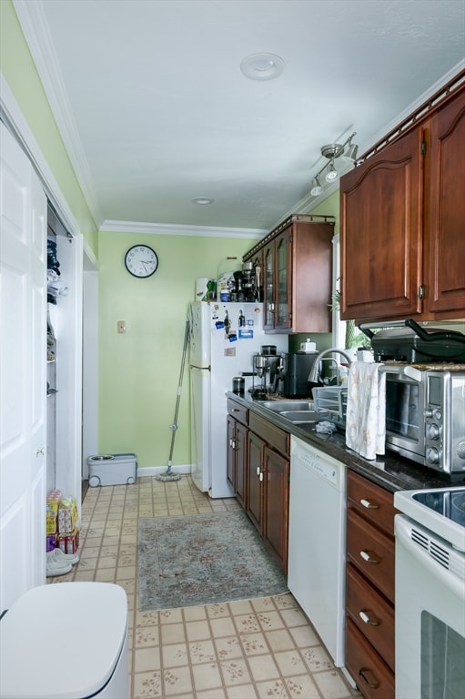 kitchen featuring white appliances, ornamental molding, baseboard heating, and sink