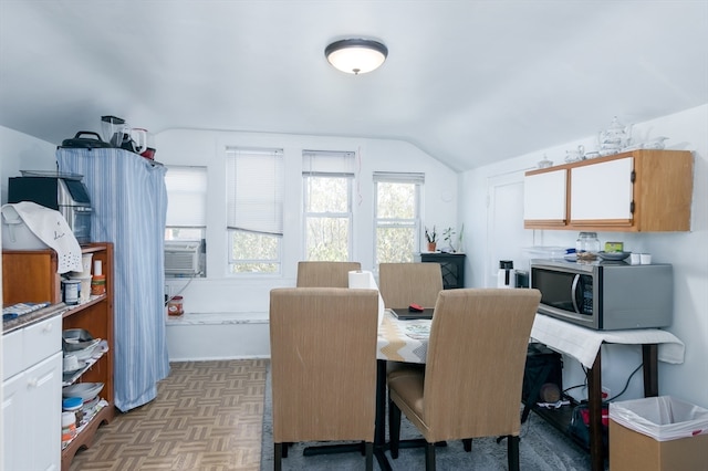 dining room with lofted ceiling and light parquet flooring