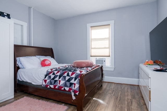 bedroom with dark wood-type flooring and cooling unit