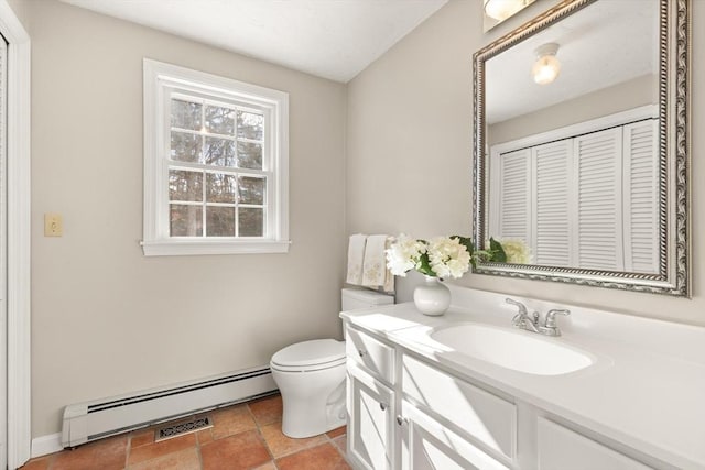 bathroom featuring a baseboard heating unit, vanity, and toilet