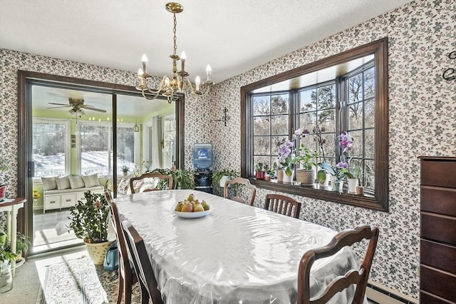 dining space featuring baseboard heating, ceiling fan with notable chandelier, and a textured ceiling