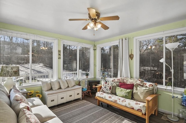 sunroom / solarium featuring ceiling fan and a healthy amount of sunlight