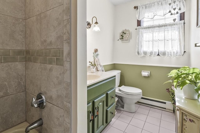 full bathroom featuring toilet, vanity, tiled shower / bath, tile patterned floors, and baseboard heating