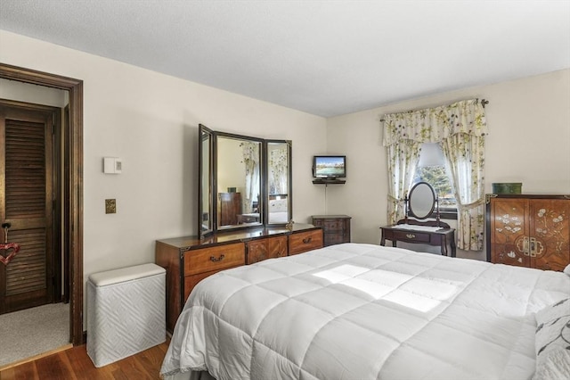 bedroom with dark hardwood / wood-style floors