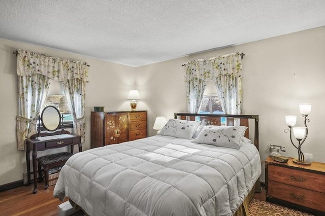 bedroom with a textured ceiling and hardwood / wood-style floors