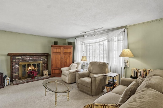 living room with light carpet, a textured ceiling, rail lighting, and a fireplace