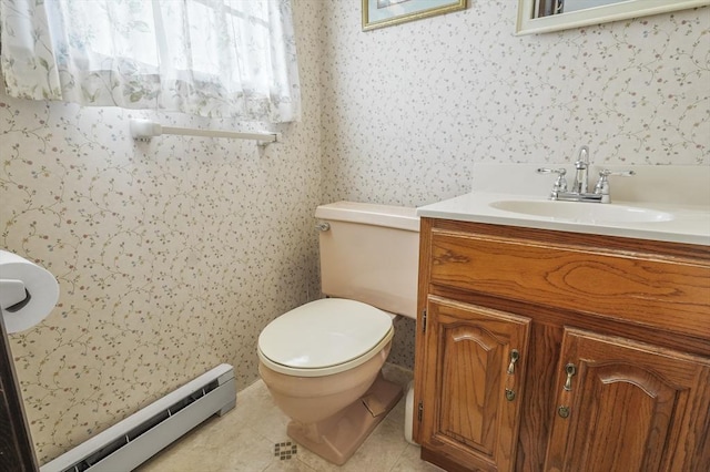 bathroom with toilet, vanity, baseboard heating, and tile patterned floors