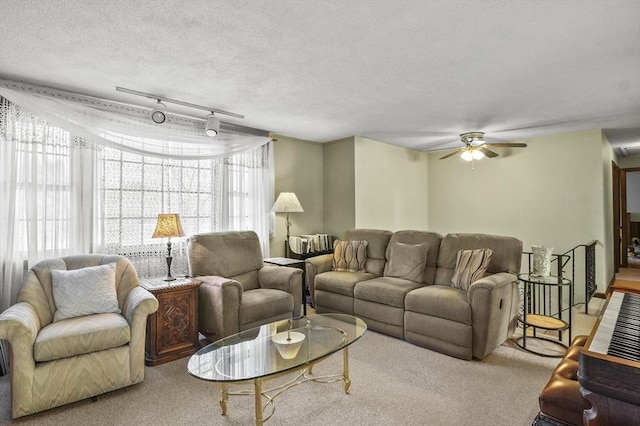 carpeted living room with a textured ceiling, ceiling fan, and rail lighting