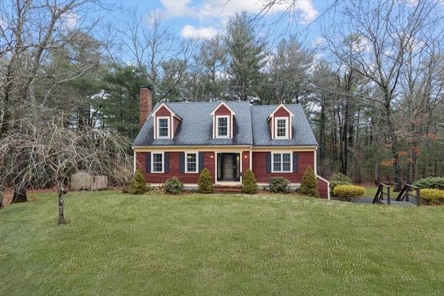 cape cod house with a front lawn and a chimney