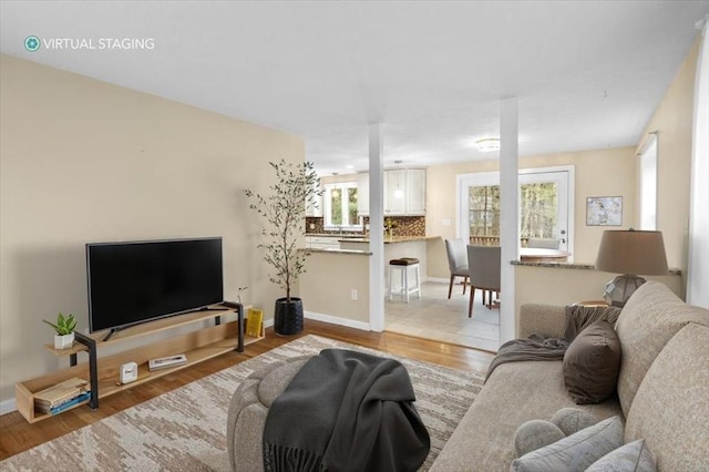 living room with baseboards and wood finished floors