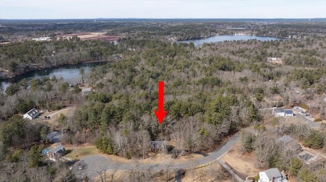 aerial view featuring a view of trees and a water view