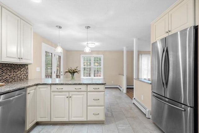 kitchen with a baseboard heating unit, decorative light fixtures, decorative backsplash, a peninsula, and stainless steel appliances