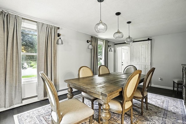 32 Nancy Rd, Milford, MA 01757 - dining room featuring dark wood finished floors, healthy amount of natural light, and a textured ceiling