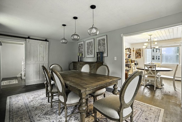 32 Nancy Rd, Milford, MA 01757 - dining space with a barn door, wood finished floors, and a chandelier