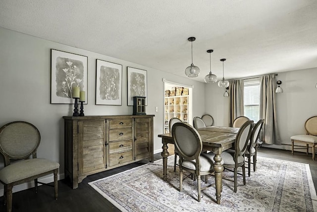 32 Nancy Rd, Milford, MA 01757 - dining area with a textured ceiling, dark wood-style floors, and baseboard heating