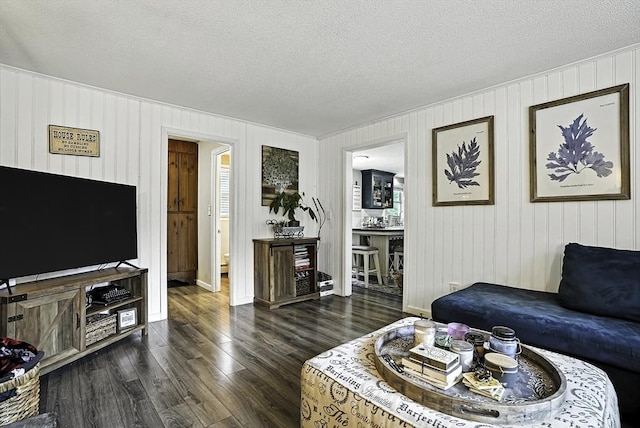 32 Nancy Rd, Milford, MA 01757 - living area with dark wood-type flooring and a textured ceiling
