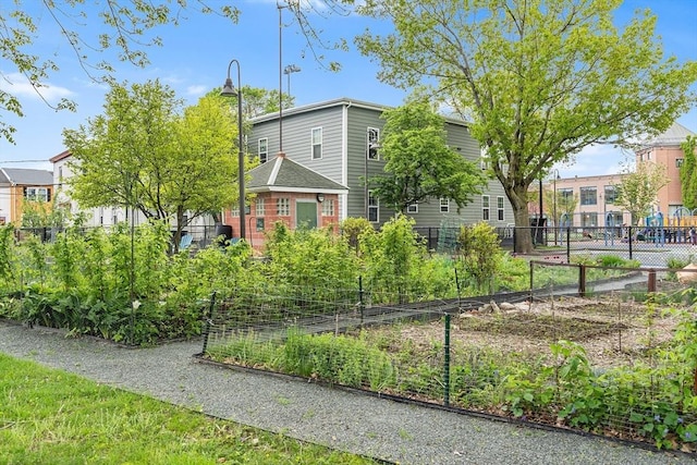 view of front facade featuring a garden and fence
