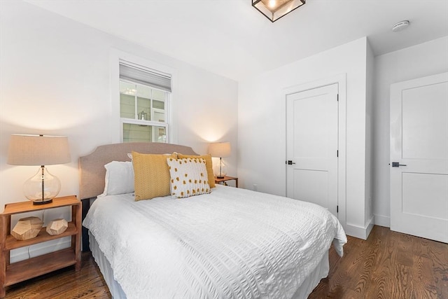 bedroom featuring wood finished floors and baseboards
