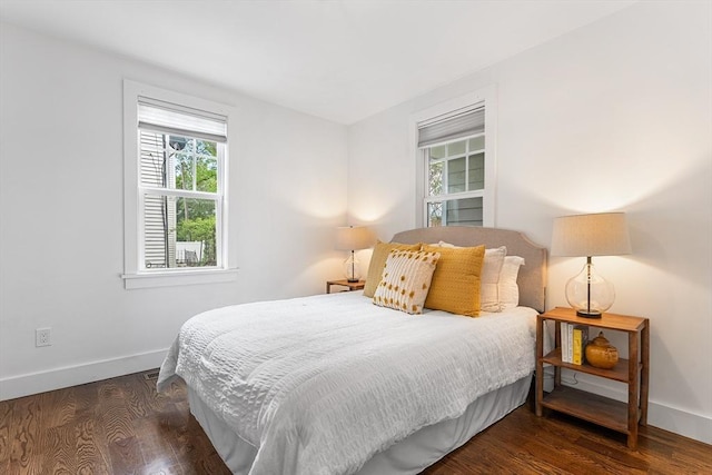 bedroom featuring baseboards and wood finished floors