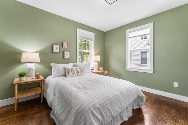 bedroom with baseboards and wood finished floors