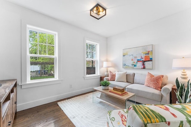 living area with baseboards and dark wood finished floors