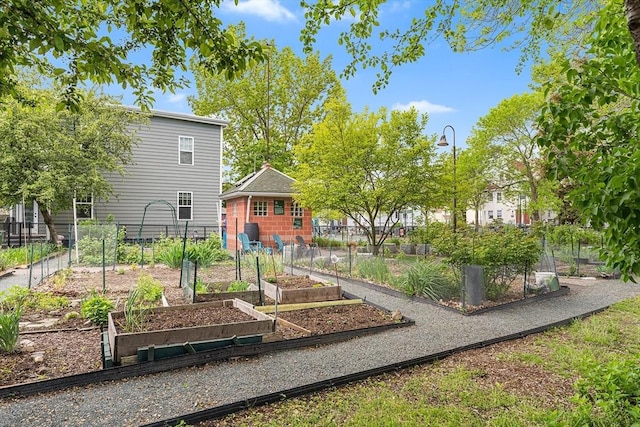 view of playground with a garden and fence
