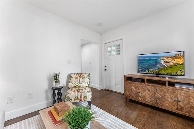 living area with wood finished floors and baseboards