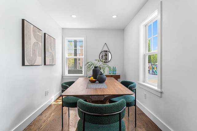 dining room featuring baseboards, wood finished floors, and recessed lighting