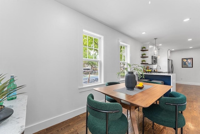 dining area featuring wood finished floors, baseboards, and recessed lighting