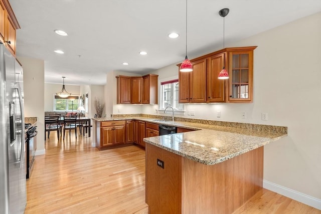 32 Old Framingham Rd Unit 34, Sudbury, MA 01776 - kitchen featuring a peninsula, brown cabinetry, gas range oven, light wood finished floors, and recessed lighting
