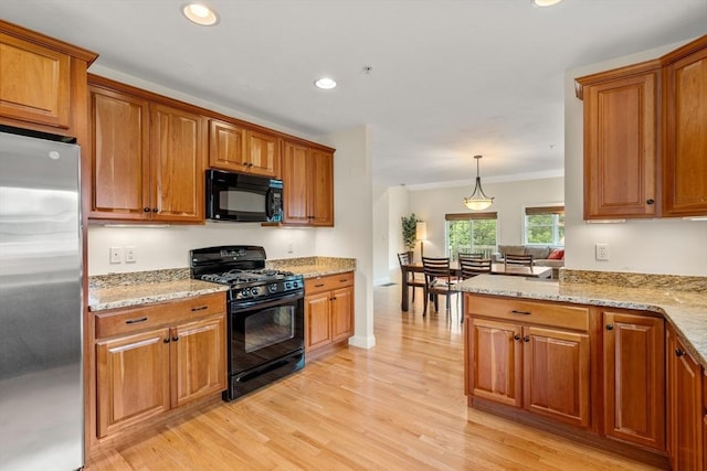 32 Old Framingham Rd Unit 34, Sudbury, MA 01776 - kitchen featuring black appliances, brown cabinets, light wood finished floors, recessed lighting, and light stone counters