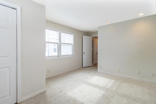 unfurnished bedroom featuring light carpet