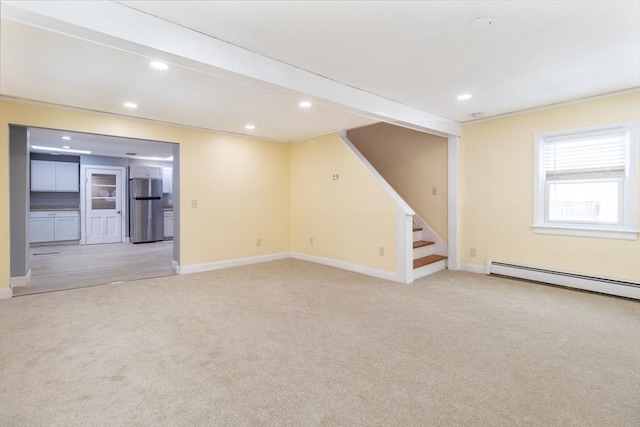 interior space featuring light carpet and baseboard heating