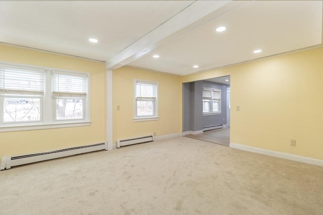 carpeted spare room with beam ceiling and baseboard heating