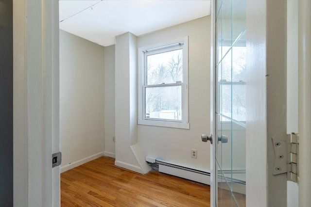 bathroom with hardwood / wood-style floors and a baseboard heating unit