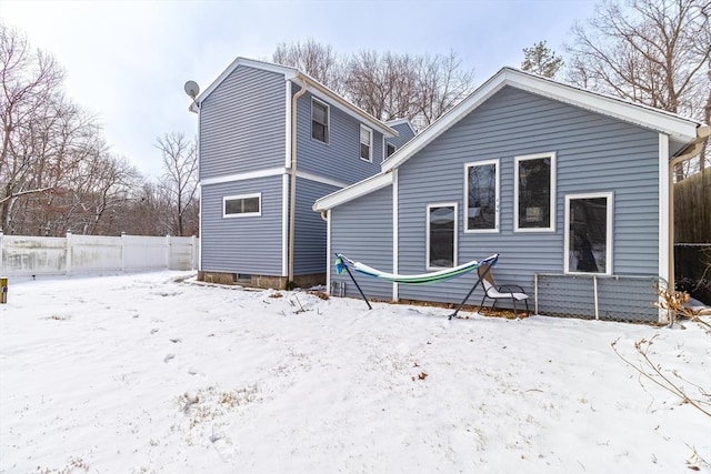 view of snow covered rear of property