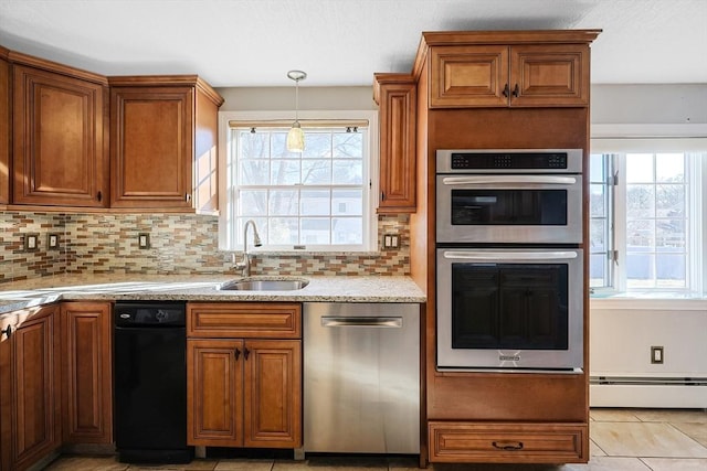 kitchen with tasteful backsplash, sink, stainless steel appliances, and a baseboard heating unit