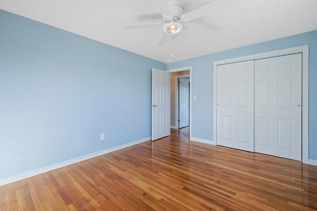 unfurnished bedroom featuring wood-type flooring, a closet, and ceiling fan