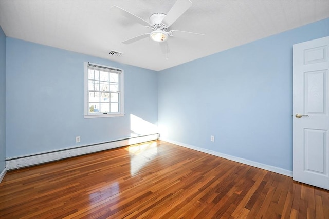 empty room featuring wood-type flooring, baseboard heating, and ceiling fan