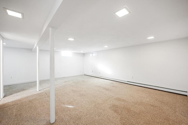 basement with light carpet and a baseboard radiator