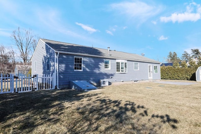 rear view of house with a lawn and ac unit