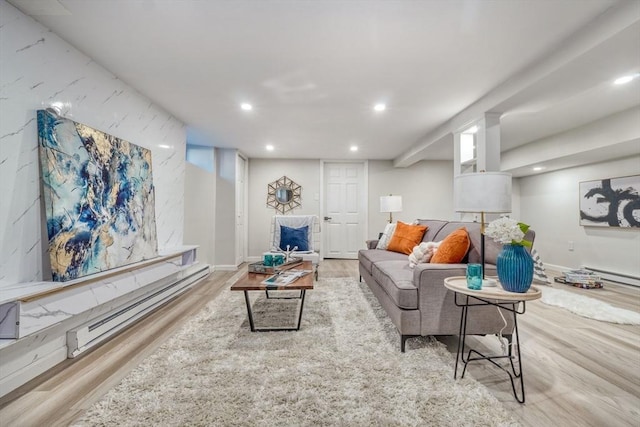 living room featuring baseboard heating and light hardwood / wood-style floors