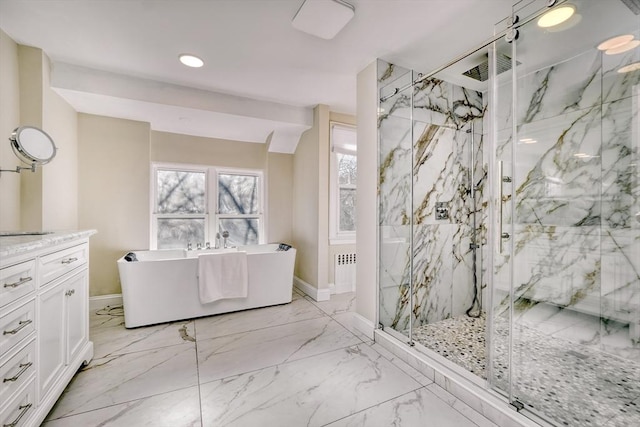 bathroom with vanity and shower with separate bathtub