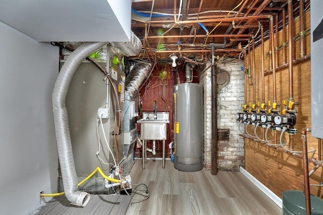 utility room featuring water heater and sink