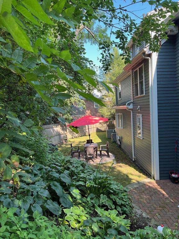 view of yard with cooling unit and a patio area