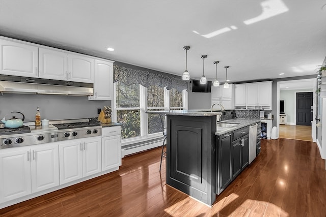 kitchen featuring pendant lighting, light stone countertops, white cabinetry, and a kitchen island with sink