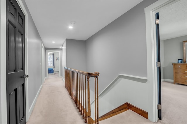 hall with light colored carpet