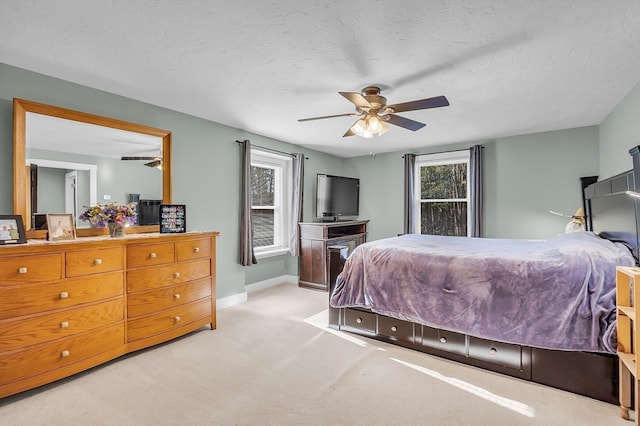 carpeted bedroom with a textured ceiling and ceiling fan