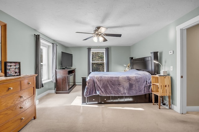 bedroom with light carpet, a textured ceiling, and ceiling fan