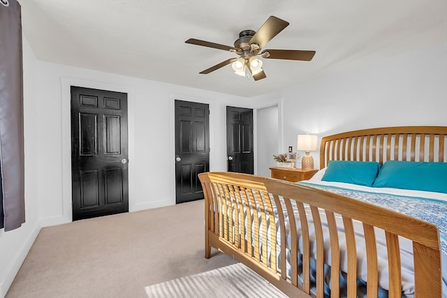 bedroom featuring ceiling fan and light carpet